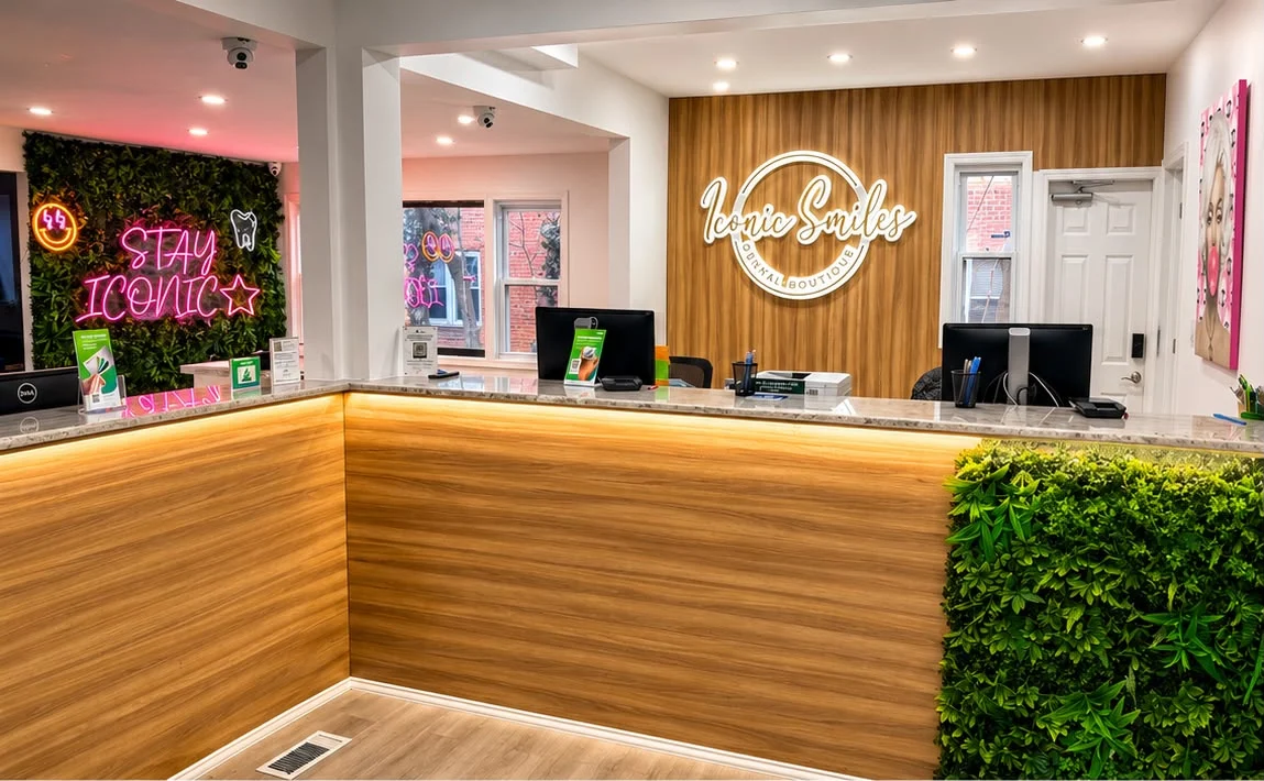 The reception desk and green feature wall inside Iconic Smiles Bellerose